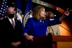 House Speaker Nancy Pelosi of Calif., accompanied by Rep. Dan Kildee, D-Mich., left, and Rep. Danny Davis, D-Ill., speaks at a news conference on Capitol Hill July 24, 2020, on the extension of federal unemployment benefits.