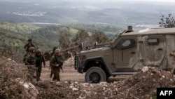 This picture taken on Oct. 13, 2024 during a controlled embed organized by the Israeli military, shows Israeli troops patrolling in the southern Lebanon's Naqoura region near the border. 