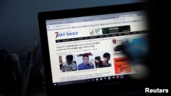 A reporter shows the news about journalists who were detained by Myanmar military, in the Democratic Voice of Burma (DVB) news room in Yangon, June 29, 2017. 