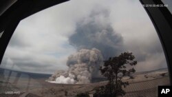 This May 26, 2018, remote image from the U.S. Geological Survey Hawaiian Volcano Observatory tower shows explosive episodes at Halema'uma'u overlook vent at Kilauea's volcano's summit, which scientists say are caused by magma withdrawing from a shallow reservoir beneath the east margin of the crater, in Hawaii Volcanoes National Park on the island of Hawaii. 