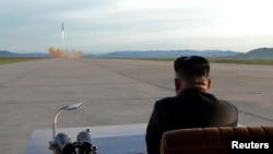 North Korean leader Kim Jong Un watches the launch of a Hwasong-12 missile in this undated photo released by North Korea's Korean Central News Agency, Sept. 16, 2017.