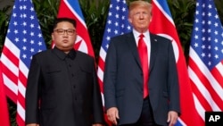  U.S. President Donald Trump, right, meets with North Korean leader Kim Jong Un on Sentosa Island, in Singapore, June. 12, 2018. 