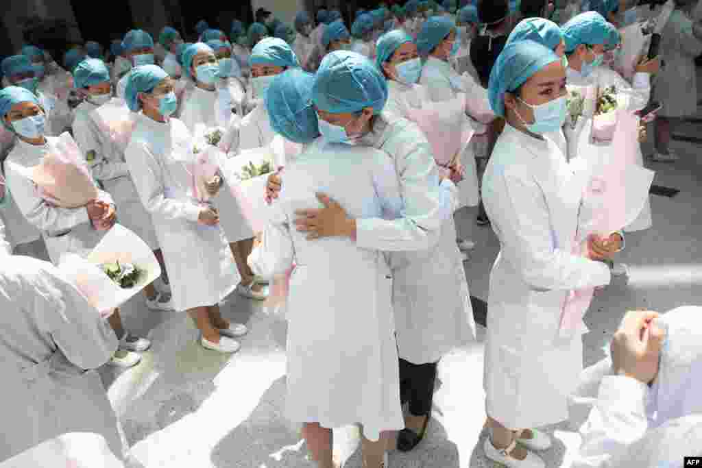 Nurses embrace during a ceremony marking International Nurses Day, at Tongji Hospital in Wuhan, in China's central Hubei province.