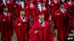 Students perform during an annual ritual ceremony to celebrate the Chinese philosopher and teacher Confucius' birthday.