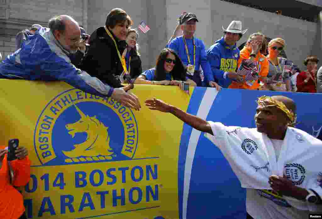 Meb Keflezighi of the U.S. (right) is congratulated after winning the men's division of the 118th running of the Boston Marathon.&nbsp; Keflezighi is the first U.S. male athlete to win the Boston Marathon in three decades, Boston, Mass., April 21, 2014.