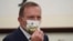 FILE - Former Australian Prime Minister Tony Abbott wears a mask with the Chinese character for "Australia" during a meeting with Taiwanese President Tsai Ing-wen, Oct. 7, 2021, at the Presidential Office in Taipei, Taiwan.