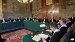 Presiding judge of the Court Peter Tomka (eighth from left) reads the verdict at the International Court of Justice in The Hague, Netherlands, July 20, 2012, ordering the prosecution of former Chadian dictator Hissene Habre.