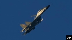 FILE - A Chinese J-11 fighter jet flies above the Taiwan Strait on Aug. 5, 2022. Taiwan reported on Dec. 23, 2023, that Chinese warships and warplanes, including J-11 jets, intruded on its territory.