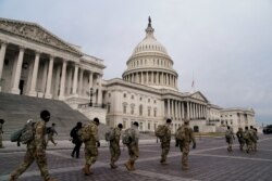 Members of the National Guard arrive to the U.S. Capitol days after supporters of U.S. President Donald Trump stormed the Capitol in Washington, D.C.