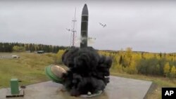 FILE - In this undated photo distributed by Russian Defense Ministry Press Service, an intercontinental ballistic missile lifts off from a silo in Russia. The Russian military said the Avangard hypersonic weapon entered combat duty on Dec. 27, 2019. 