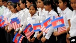FILE PHOTO - Students from a local high school carry the U.S. national flags and Cambodia's national flags in Siem Reap, Cambodia, Saturday, March 21, 2015. (AP Photo/Wong Maye-E)