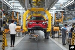 FILE - Workers assemble a car at a Vinfast factory in Hai Phong, Vietnam, on Sept. 29, 2023. (AP Photo/Hau Dinh)