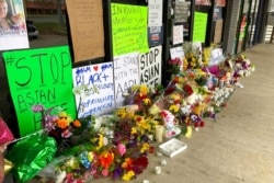 A makeshift memorial is seen March 19, 2021, in Acworth, Ga., in the aftermath of shootings that left eight people dead at three metro Atlanta massage businesses.