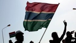 FILE - Gambians celebrate the victory of opposition coalition candidate Adama Barrow against longtime President Yahya Jammeh in the streets of Serrekunda, Gambia, Dec. 2, 2016. 