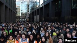 Workers stand outside the Google offices after walking out as part of a global protest over workplace issues in Dublin, Ireland, Nov. 1, 2018. 