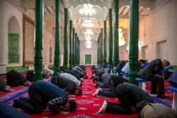 Uyghurs and other members of the faithful pray at the Id Kah Mosque in Kashgar in western China's Xinjiang Uyghur Autonomous Region, as seen during a government organized trip for foreign journalists, April 19, 2021.