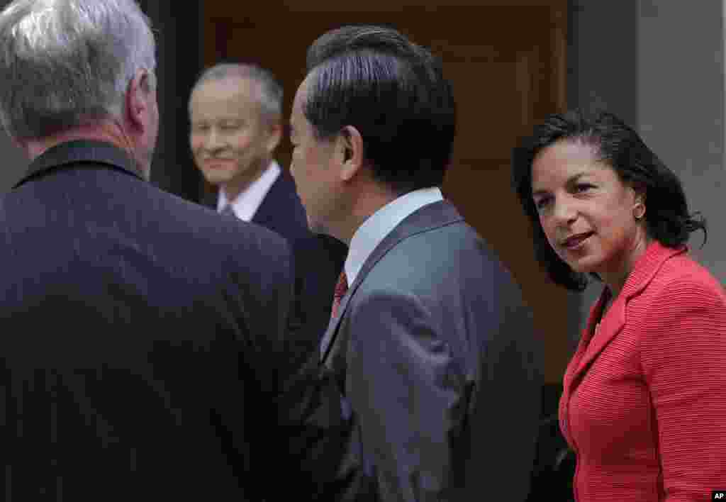 U.S. National Security Adviser Susan Rice chats with Chinese Foreign Minister Wang Yi (center) and U.S. Ambassador to China Max Baucus (left) as they head to a meeting at the Foreign Ministry office in Beijing, Sept. 9, 2014.