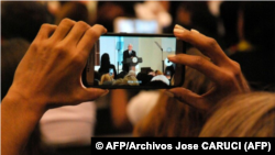 People perform on traditional horsehide skis during an event to celebrate the origins of skiing at the Jiangjunshan, or General's Mountain, ski resort in Altay, Xinjiang, Uighur Autonomous Region, China, Nov. 27, 2019.