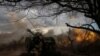 FILE PHOTO: Ukrainian service members fire a howitzer D30 at a front line near the city of Bakhmut