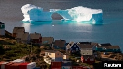 FILE - An iceberg floats near a harbor in the town of Kulusuk, east Greenland August 1, 2009.