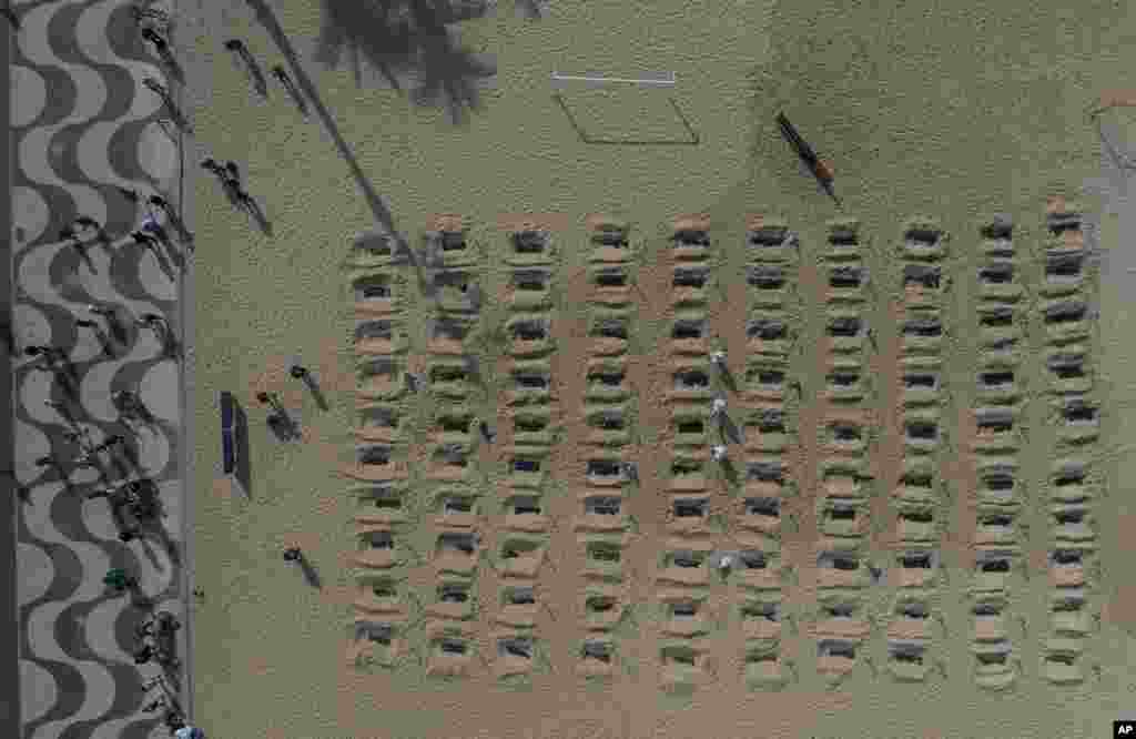 Activists dig symbolic graves on Copacabana beach as a protest, organized by the NGO Rio de Paz, against the government's handling of the COVID-19 pandemic in Rio de Janeiro, Brazil.