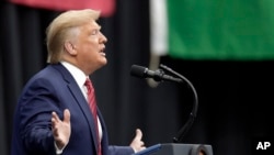 President Donald Trump shakes hands with Indian Prime Minister Narendra Modi during the "Howdy Modi: Shared Dreams, Bright Futures" event at NRG Stadium in Houston, Sept. 22, 2019.