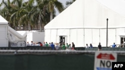 Migrant children who have been separated from their families can be seen in tents at a detention center in Homestead, Florida on June 27, 2019