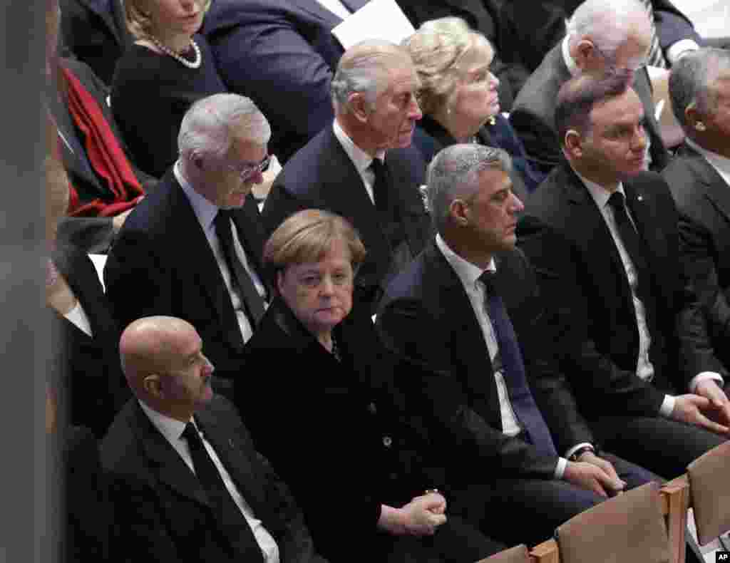 Britain's Prince Charles, second from left, back row, and German Chancellor Angela Merkel, second from left, bottom row, are shown seated during a State Funeral for former President George H.W. Bush at the National Cathedral, Dec. 5, 2018.