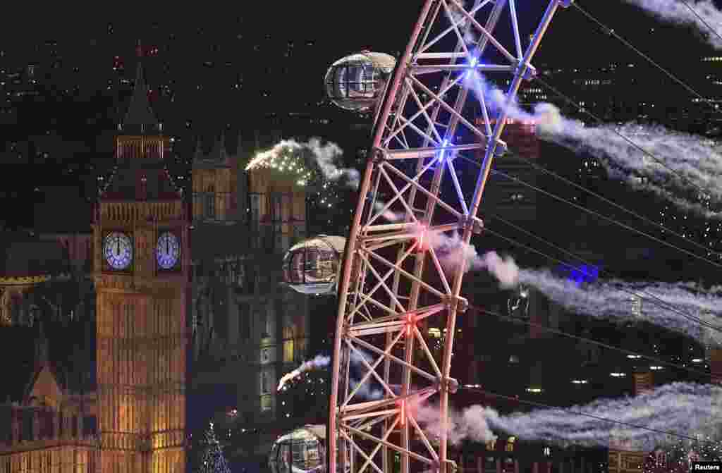 Fireworks explode around the London Eye Ferris wheel, the Big Ben clock tower and the houses of Parliament to mark the beginning of the New Year in London, Jan. 1, 2016.