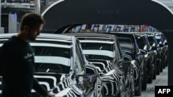 (แฟ้ม) A line of electric vehicles of the model Y is pictured during the start of the production at Tesla's "Gigafactory" plant on March 22, 2022 in Gruenheide, southeast of Berlin. (Patrick Pleul / POOL / AFP)