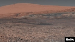 This mosaic image, taken by NASA's Mars Curiosity rover, looks uphill at the Mars mountain Mount Sharp. (NASA)