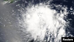 Tropical Storm Dorian is shown in this photo taken by NASA's Aqua satellite MODIS instrument as it moved over the Leeward Islands, as it continues its track into the Eastern Caribbean Sea, August 27, 2019. Picture taken August 27, 2019. NASA Worldview, Ea