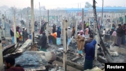 A view of burned houses after a fire broke out at the Nayapara refugee camp in Cox's Bazar, Bangladesh, January 14, 2021. (REUTERS/Mohammed Arakani)
