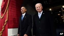 FILE - President Barack Obama and Vice President Joe Biden arrive for the Presidential Inauguration of Donald Trump at the U.S. Capitol in Washington. 