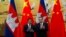 Cambodian Prime Minister Hun Sen, left, applauds with Chinese Premier Li Keqiang during a signing ceremony at the Great Hall of the People in Beijing, China, Tuesday, Jan. 22, 2019. (AP Photo/Ng Han Guan, Pool)