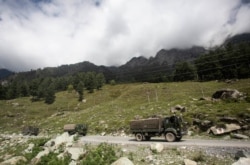 An Indian army convoy moves on the Srinagar- Ladakh highway at Gagangeer, northeast of Srinagar, Indian-controlled Kashmir, Sept. 1, 2020.