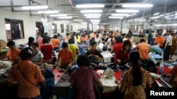 Workers tailor and arrange clothing at a garment factory at Hlaing Tar Yar industry zone 