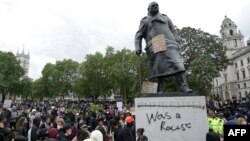 The statue of former British prime minister Winston Churchill is seen defaced, with the words (Churchill) "was a racist" written on it's base in Parliament Square, central London after a demonstration outside the US Embassy, on June 7, 2020.
