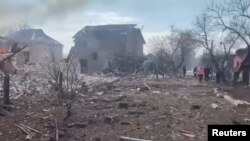 The aftermath of artillery shelling by Russia is seen on a residential area, in Mariupol