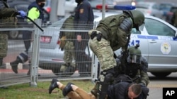 Police detain a man during an opposition rally to protest the official presidential election results in Minsk, Belarus, Nov. 1, 2020.